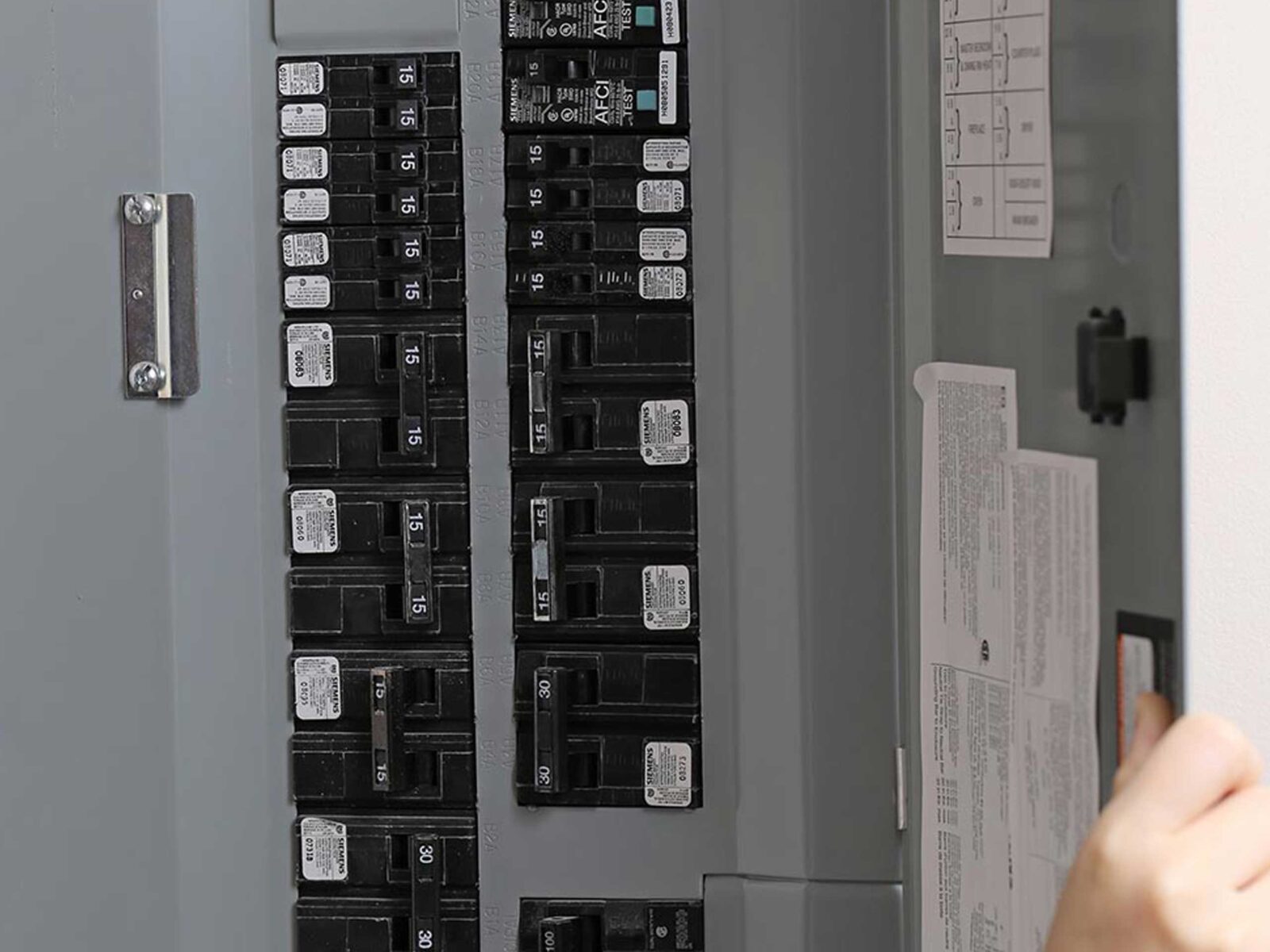 A close-up view of an electrical panel featuring multiple circuit breakers.